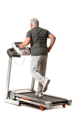 Fototapeta na wymiar Senior man training on treadmill against white background