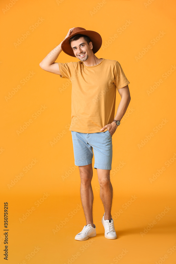 Wall mural Man in stylish t-shirt on color background