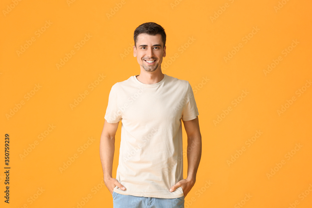 Wall mural Man in stylish t-shirt on color background