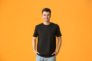 Man in stylish t-shirt on color background