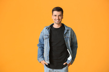 Fototapeta premium Man in stylish t-shirt on color background
