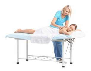Massage therapist working with female patient on white background