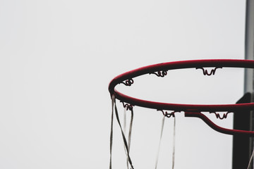 Basketball Hoop with a Net Waving in the Wind on a White Background