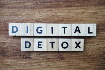 Digital Detox alphabet letter on wooden background