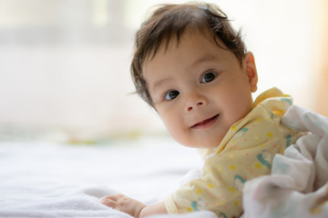 Fototapeta premium Happy baby boy playing on bed
