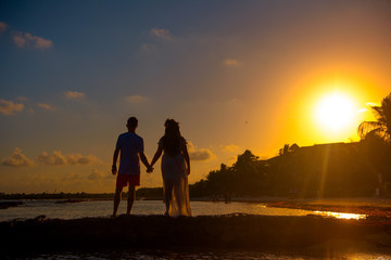 Silhouettes of men and women against the backdrop