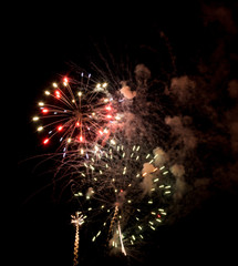 Explosive colorful fireworks display celebrating the fourth of July holiday leaving room for copy..