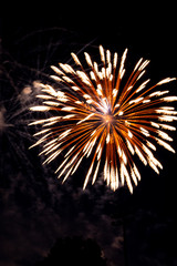 Explosive colorful fireworks display celebrating the fourth of July holiday leaving room for copy..