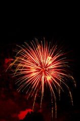 Fototapeta na wymiar Explosive colorful fireworks display celebrating the fourth of July holiday leaving room for copy..