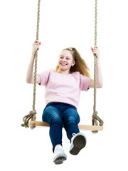 Beautiful teen school girl swinging on a swing.