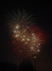 Fototapeta premium Explosive colorful fireworks display celebrating the fourth of July holiday leaving room for copy..