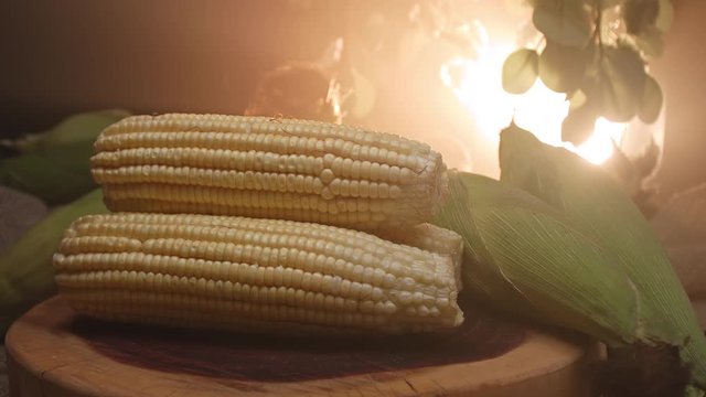 Three corns stacked on top of a wooden board