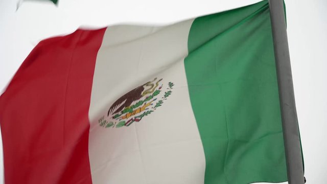 4K SHOT OF MEXICAN FLAG WAVING IN THE WIND 
