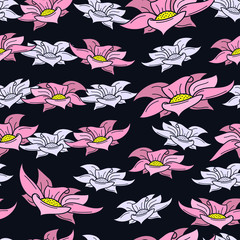 Floral seamless pattern of pink and pastel blue hand drawn flowers on a dark blue background. Designed for printing on fabric.