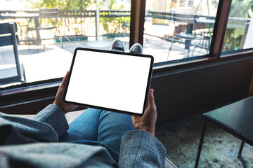 Mockup image of a woman holding black tablet pc with blank white desktop screen