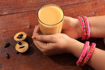 Ripe fresh whole and half of sapota fruit isolated on white background, Indian Chikoo

