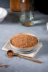 Fresh buckwheat seeds on grey background
