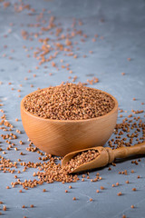 Fresh buckwheat seeds on grey background