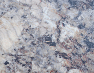 White marble with streaks of gray and black impregnations.