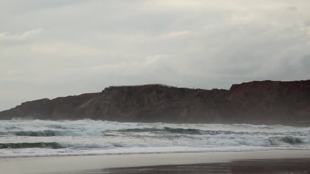Two surfers enjoying the powerful ocean waves. Parque Natural do Sudoeste Alentejano e Costa Vicentina
