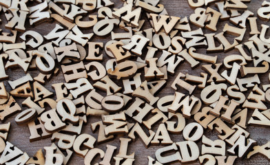 Wooden letters on wooden background. english alphabet.