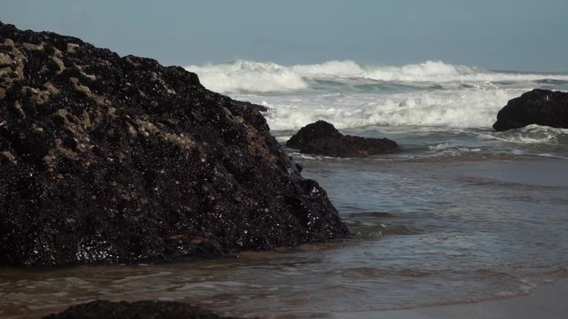 Powerful ocean waves rolling onto the beach. Cresmina beach (Praia da Cresmina), Portugal. 