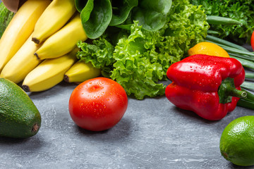 Healthy food. Vegetables and fruits. On a black wooden background.