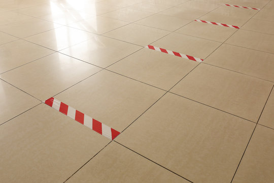 Warning sticky tape on floor indoors. Concept of social distance
