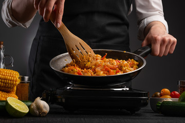 Chef cook fries noodles with shrimp and vegetables. Cooking food