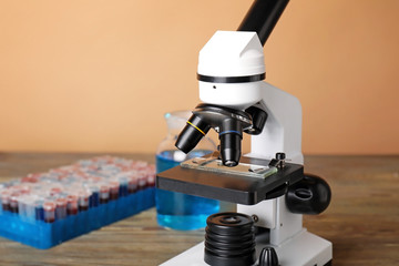 Fototapeta na wymiar Modern microscope and test tubes on table