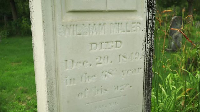 Shot pivots around William Miller grave marker stone