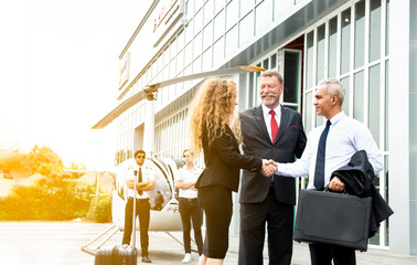 Business team shaking hand to appreciate each other about aviation business and helicopter platform background, Man and woman hands shake with partnership successful outdoors, Deal