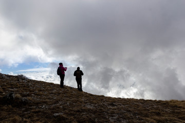 hikers in the mountains in the fog