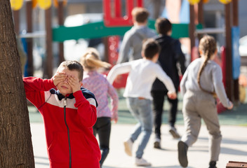 Teenage playing hide-and-go-seek in the playground