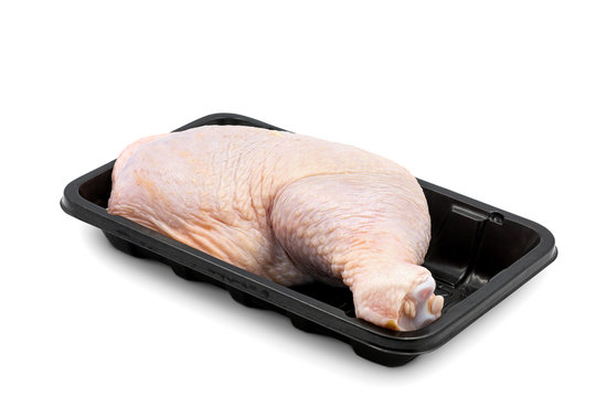 Raw fresh chicken thight or leg on black tray or plastic pack isolated on white background.Food from poultry for cooking or barbecue grill concept.