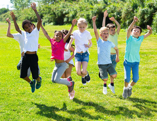 Group of happy children  jumping and smiling together