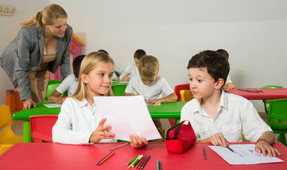 Fototapeta premium Portrait of two schoolkids and their teacher