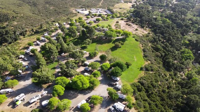 Aerial drone fly over shot of Chardonnay Mesa camping area at Vail Lake KOA RV park.