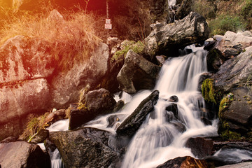 Fototapeta na wymiar Beautiful waterfall of silky water going down the mountain