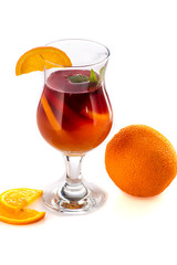 sangria or mulled wine cocktail in a glass with oranges, wine and juice on a white background