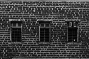 3 Vintage windows in wooden frame on a grunge damaged wall forming a pattern