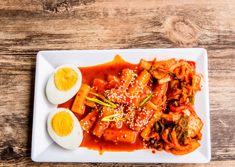 Tteokbokki or spicy rice cake and kimchi in plate , Korean famous food