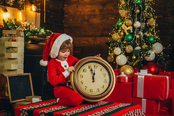 Midnight miracle. Boy play near christmas tree. New year countdown. Merry and bright christmas. Kid...