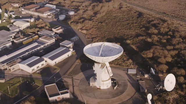 Aerial high angle of a large space searching satellite dish at a scientific research station