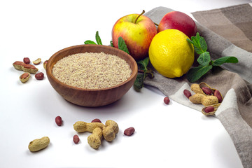 Peanut celulose in ceramic bowl, apples, lemon and mint isolated on white background 