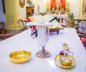 chalice for wine, blood of christ, and ciborium with host, body of christ, and ampoules with wine and water for consecration