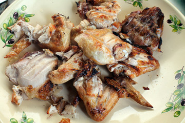 Chicken meat cooked on a bonfire in a plate.