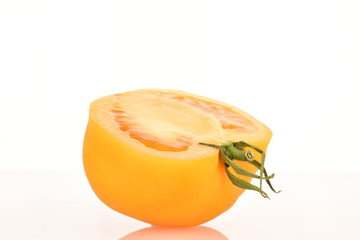Fototapeta na wymiar Ripe juicy yellow tomatoes, close-up, on a white background.