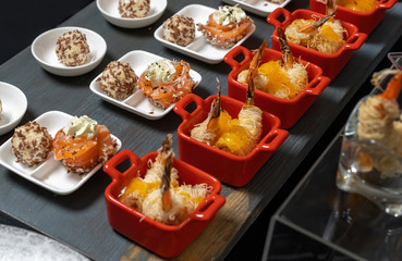 Salmon rolls, with cream cheese and butter, sprinkled with sesame seeds. Nearby are cheese balls in sesame seeds-2.