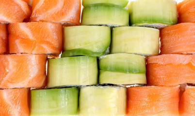 Japanese rolls, top view. With salmon, salmon and avocado.